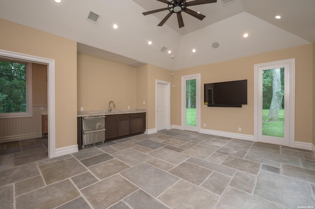 unfurnished living room featuring ceiling fan, sink, and high vaulted ceiling