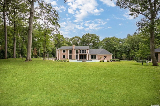 rear view of property with a yard