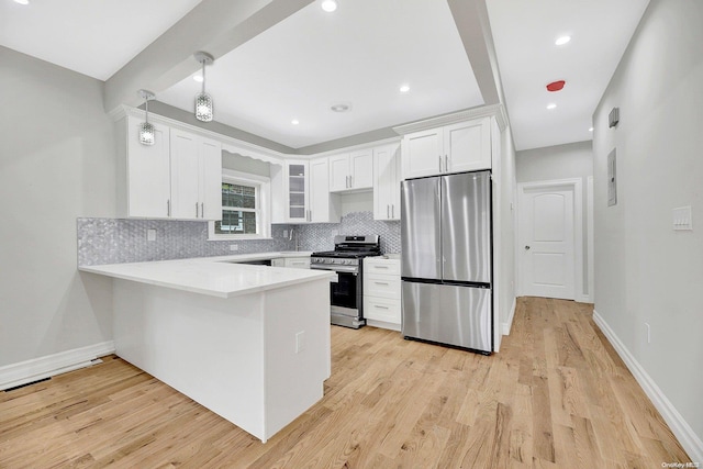 kitchen with white cabinetry, kitchen peninsula, light hardwood / wood-style floors, decorative backsplash, and appliances with stainless steel finishes