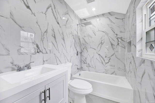 full bathroom with vanity, tiled shower / bath, decorative backsplash, toilet, and tile walls