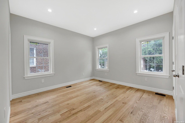 spare room with light hardwood / wood-style floors