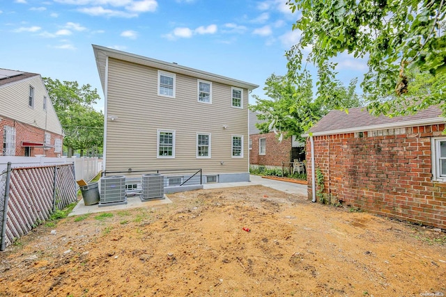 rear view of house featuring central AC