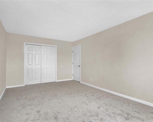 unfurnished bedroom with a closet and carpet