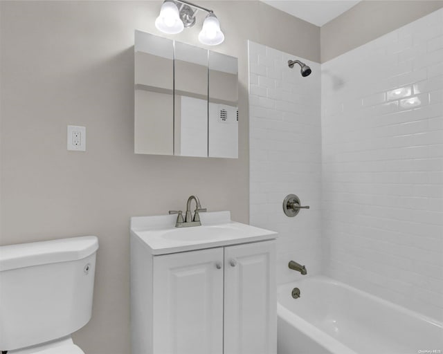 full bathroom featuring vanity, toilet, and tiled shower / bath