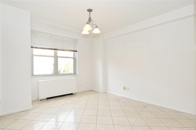 unfurnished room featuring light tile patterned floors and a notable chandelier