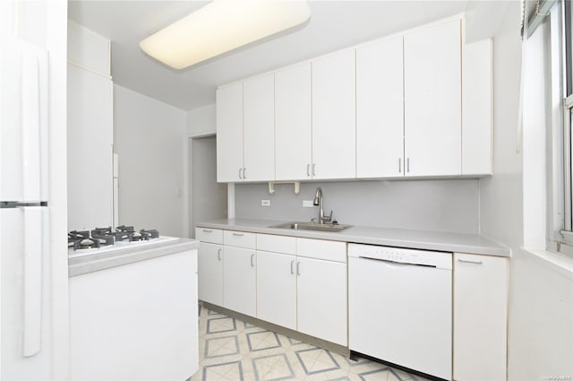 kitchen featuring white cabinets, white appliances, and sink