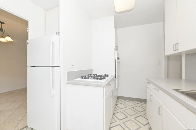 kitchen featuring white cabinets and white appliances