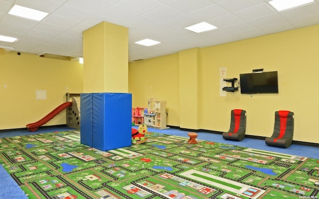 rec room featuring carpet flooring and a paneled ceiling