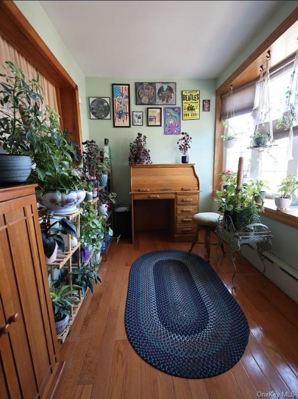 sitting room with hardwood / wood-style flooring