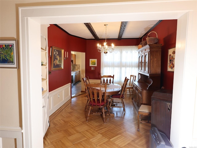 dining room featuring a notable chandelier, beam ceiling, and light parquet flooring