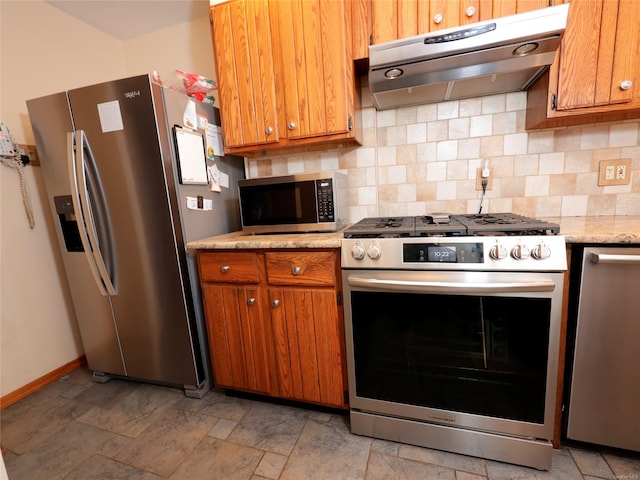 kitchen with decorative backsplash, stainless steel appliances, and exhaust hood