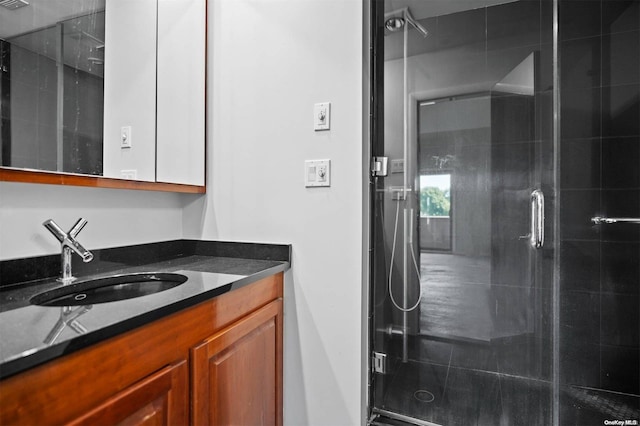 bathroom with vanity and an enclosed shower