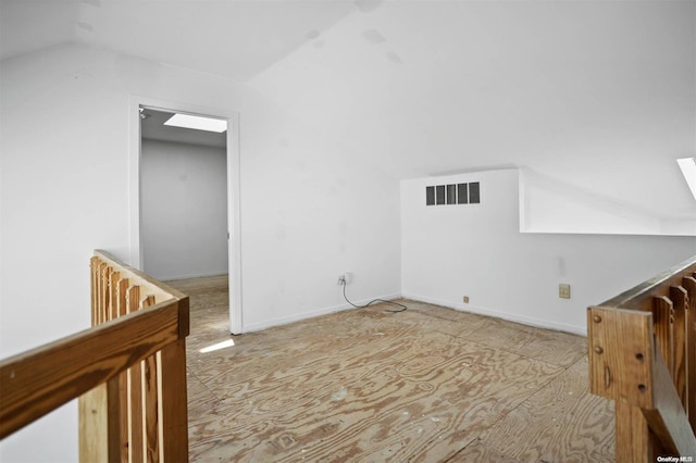 bonus room featuring vaulted ceiling with skylight