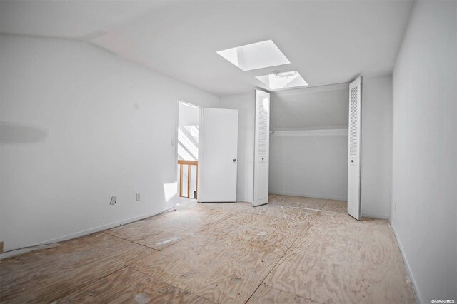 unfurnished bedroom with a skylight