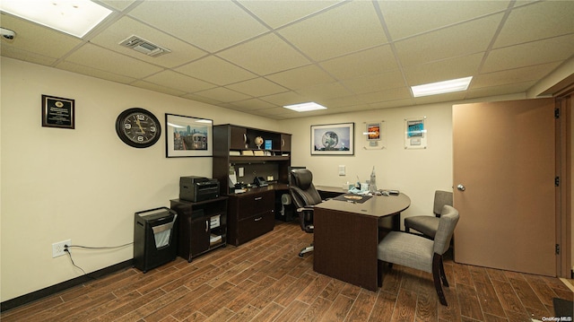 office space with dark hardwood / wood-style floors and a drop ceiling