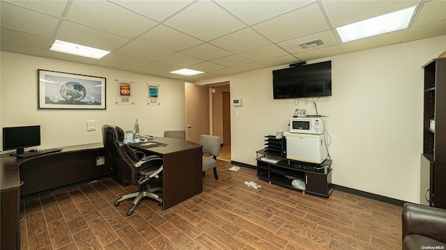 home office featuring dark hardwood / wood-style floors and a drop ceiling