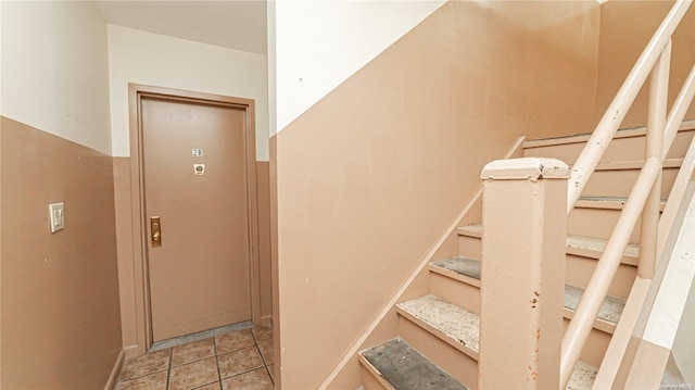 stairway featuring tile patterned floors