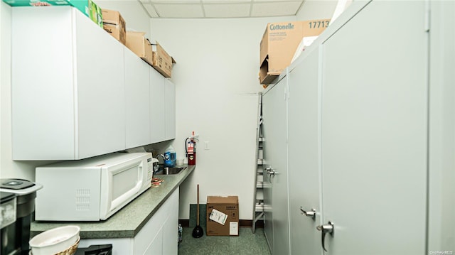 clothes washing area with sink