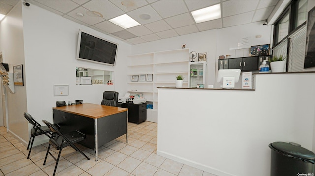 tiled home office featuring a drop ceiling