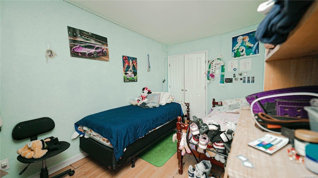 bedroom with wood-type flooring and a closet