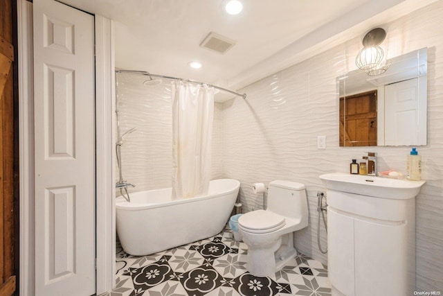 full bathroom with vanity, toilet, tile walls, and shower / tub combo with curtain