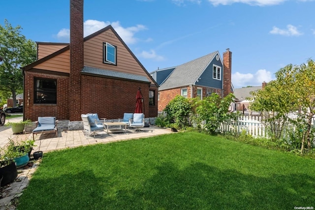 back of property with an outdoor hangout area, a yard, and a patio