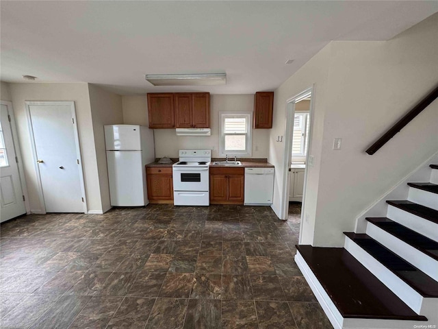 kitchen featuring white appliances and sink