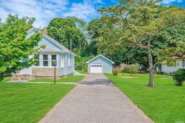 view of front of house with an outbuilding, a front lawn, and a garage