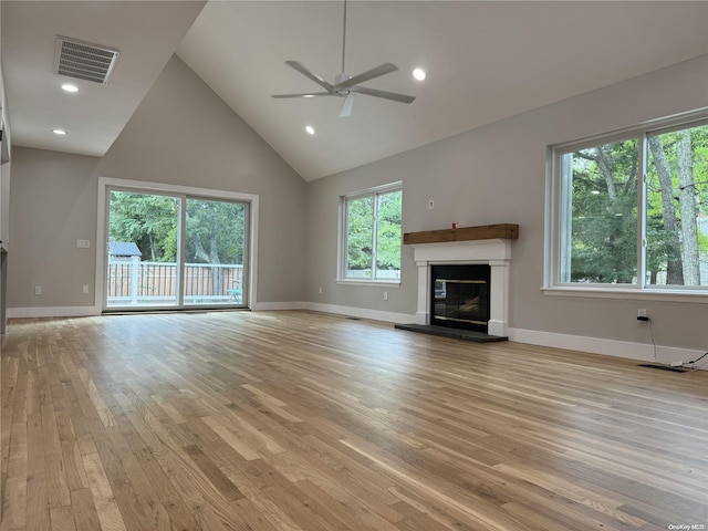 unfurnished living room featuring ceiling fan, light hardwood / wood-style flooring, and high vaulted ceiling