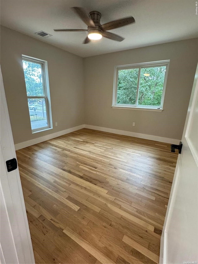 spare room featuring ceiling fan and light wood-type flooring