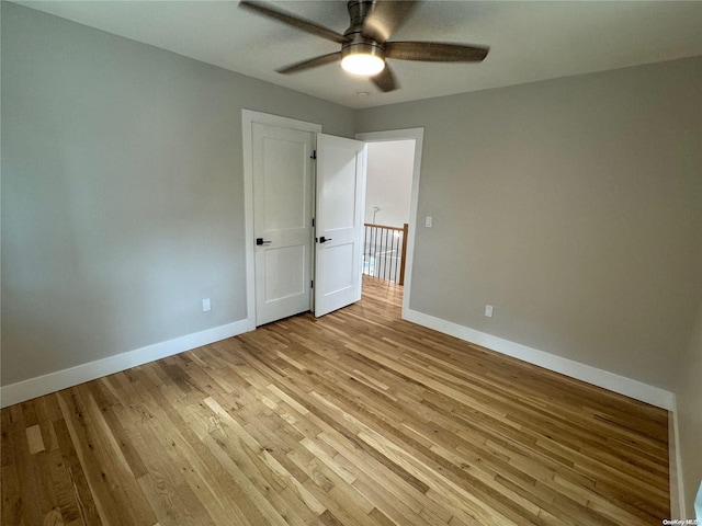 unfurnished bedroom with ceiling fan and light hardwood / wood-style floors