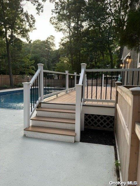 wooden deck featuring a fenced in pool