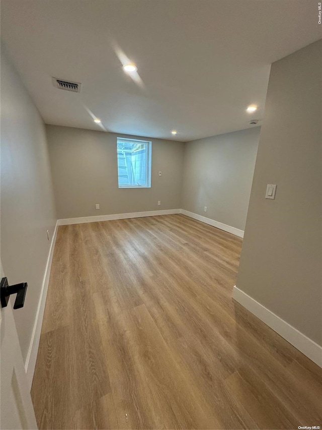 unfurnished room with light hardwood / wood-style floors