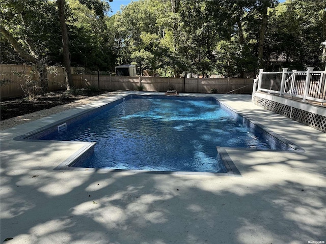 view of swimming pool with a deck