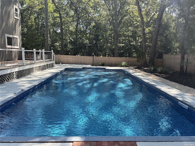 view of swimming pool with a deck