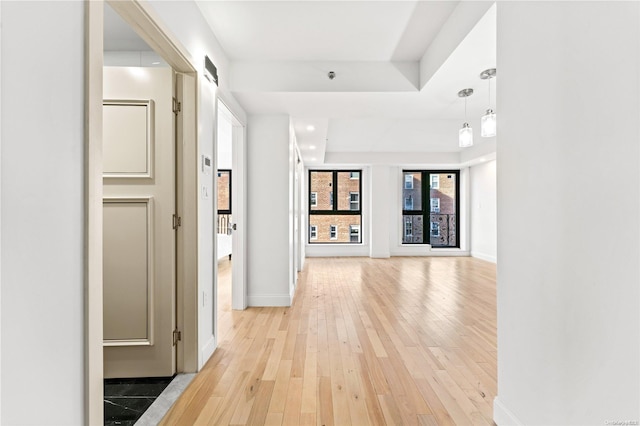 hall with light hardwood / wood-style floors