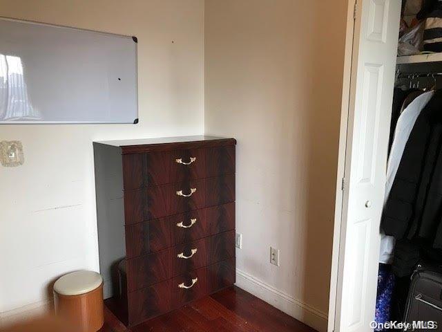 hallway with dark hardwood / wood-style flooring