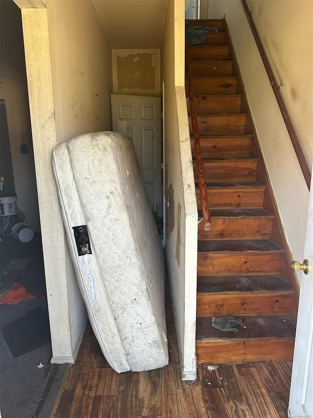 stairway featuring wood-type flooring