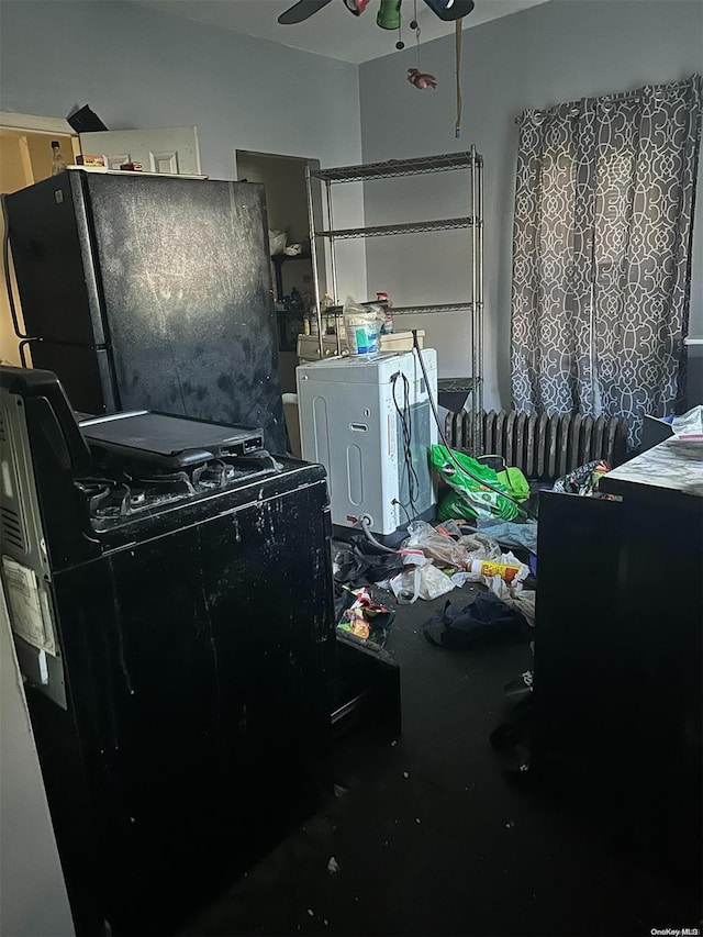 interior space with ceiling fan, black refrigerator, and washer / dryer