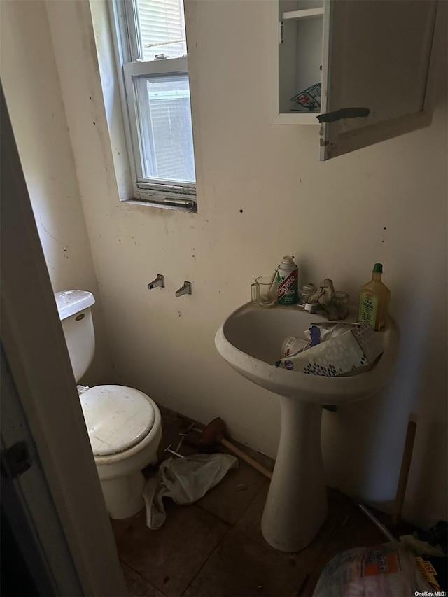 bathroom with tile patterned flooring and toilet