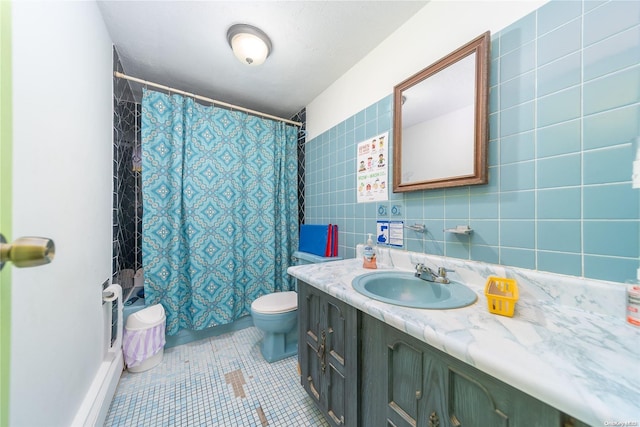 bathroom with tile patterned floors, toilet, decorative backsplash, vanity, and tile walls