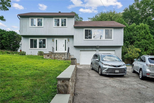 tri-level home featuring a garage and a front lawn