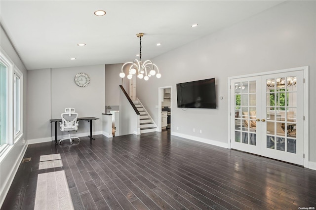 living room with a chandelier, french doors, and dark hardwood / wood-style flooring