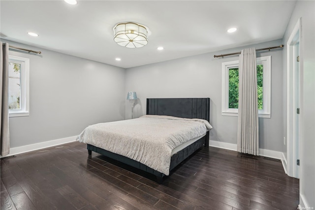 bedroom with dark hardwood / wood-style floors