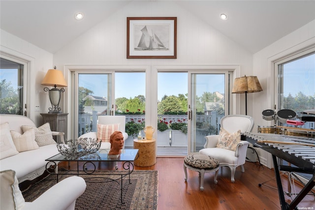 living area featuring hardwood / wood-style flooring, high vaulted ceiling, and a wealth of natural light