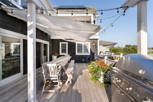 wooden deck with a grill