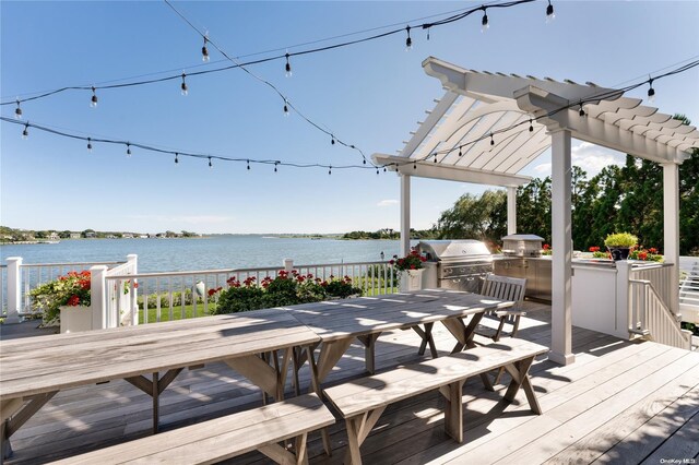 wooden deck with a pergola, a water view, and area for grilling