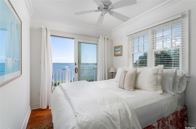 bedroom featuring ceiling fan, dark wood-type flooring, access to outside, a water view, and ornamental molding