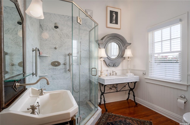 bathroom featuring an enclosed shower, wood-type flooring, and sink