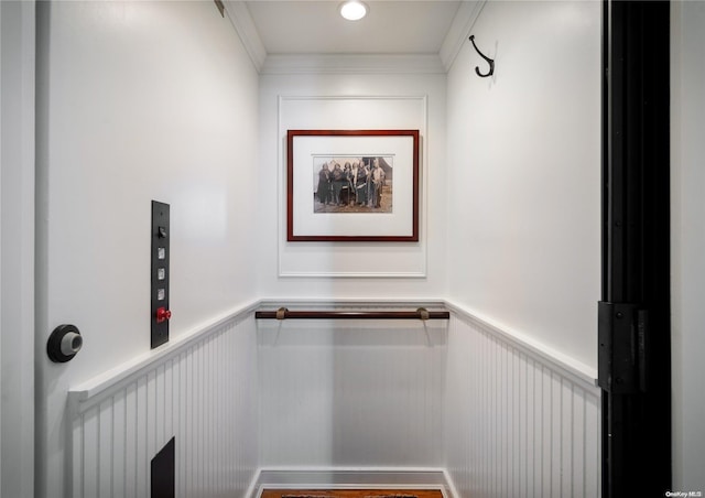 interior space with hardwood / wood-style floors and crown molding